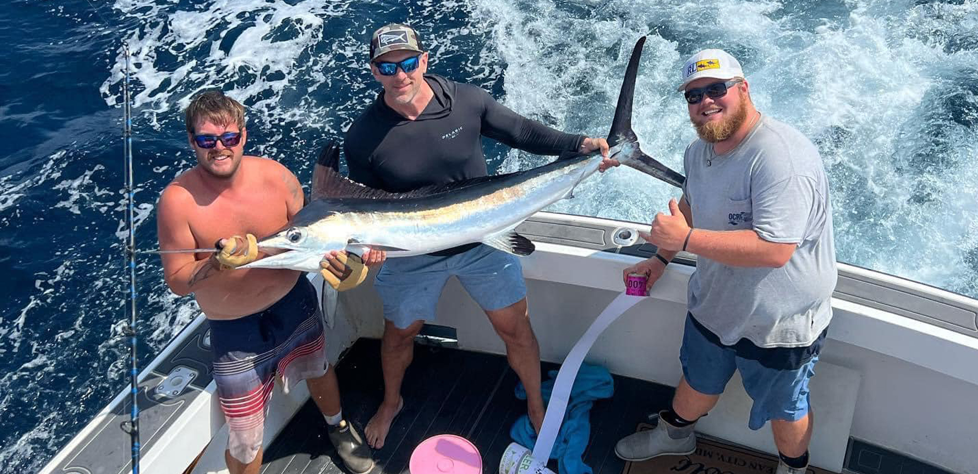 men with white marlin