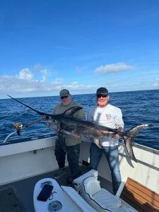 men holding fish