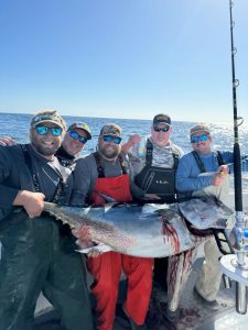 group of men holding fish